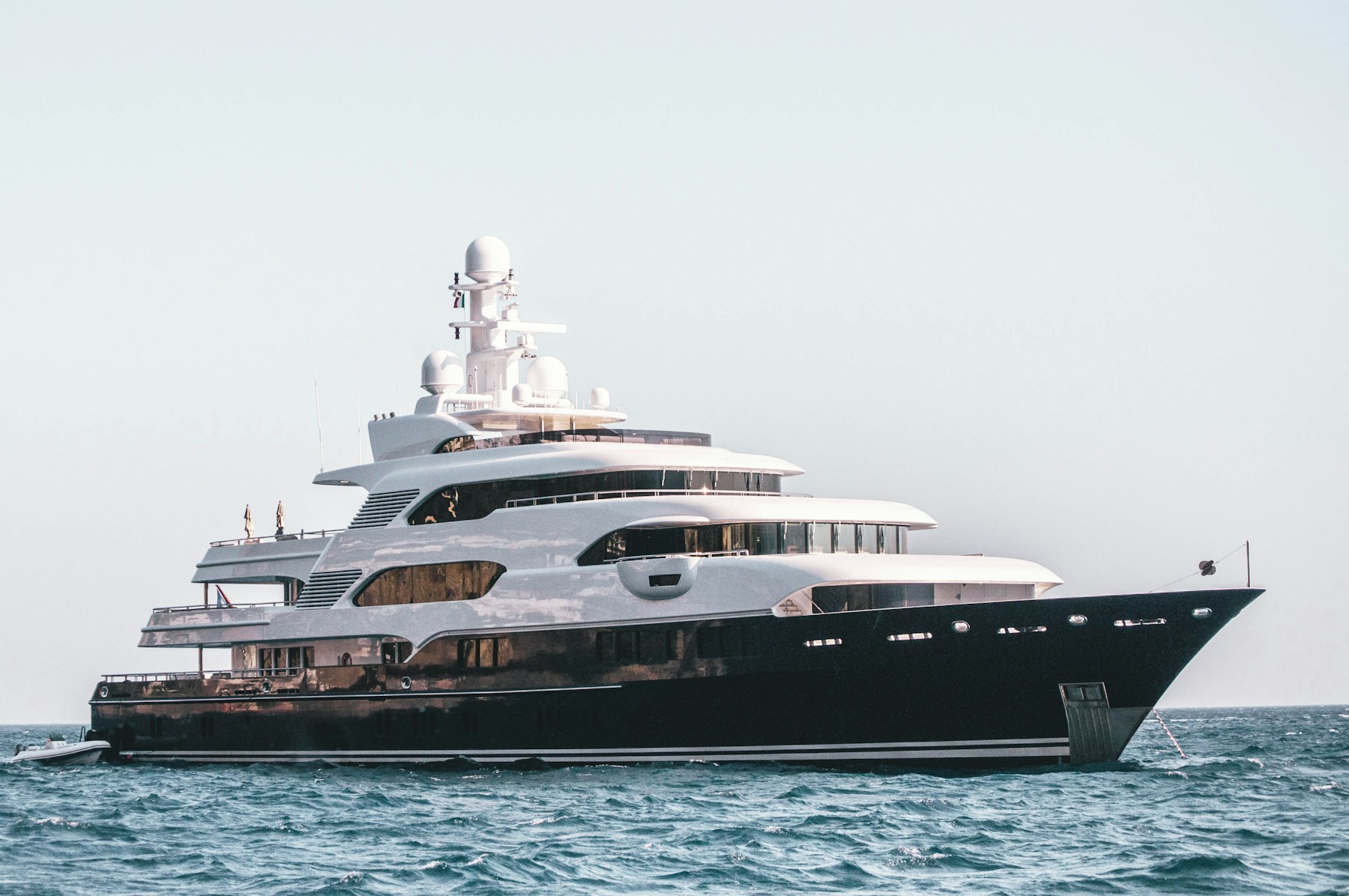 White superyacht docked in a harbor